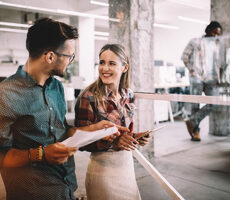Two professionals in conversation at work